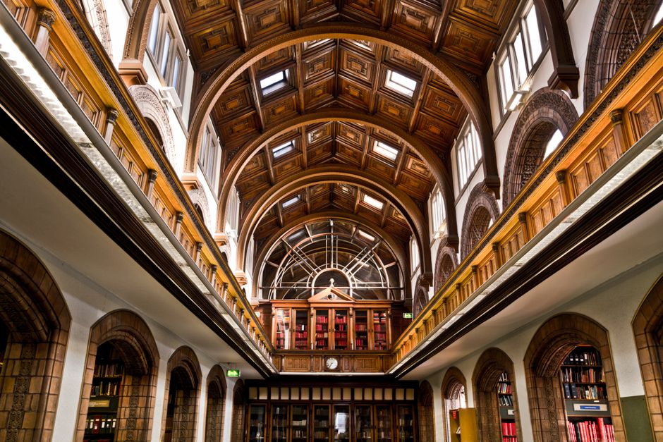 Explore the elegant and historic interior of a classic library in Manchester, England. Perfect for literature enthusiasts.